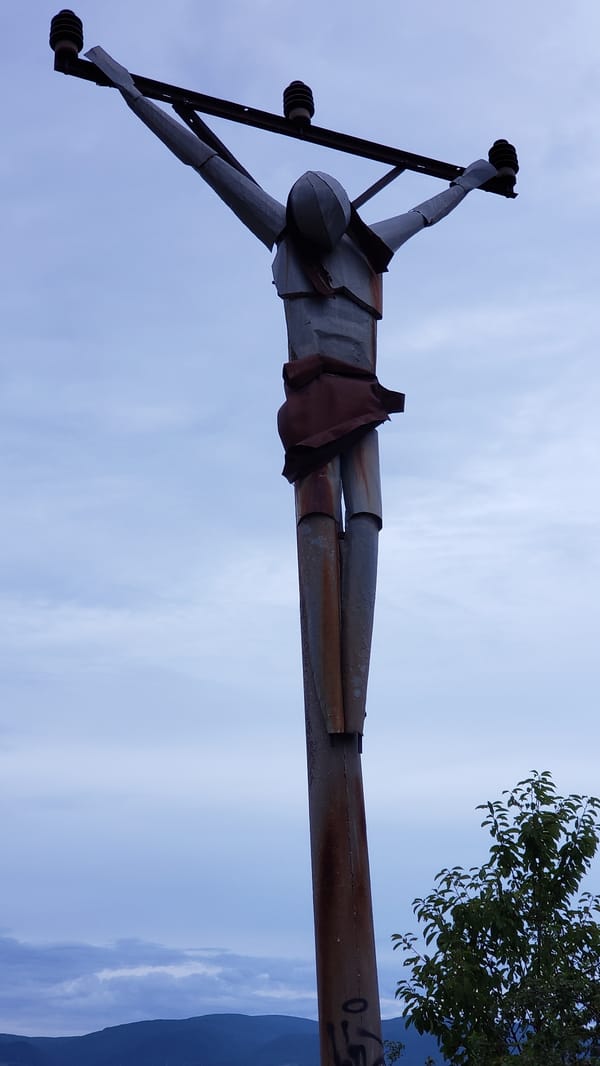 Hilltop views over Prešov at dusk, sculpture included