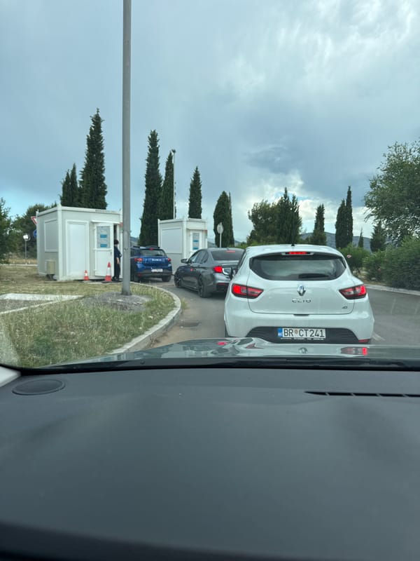 Cars queued at a checkpoint near Podgorica on a cloudy afternoon