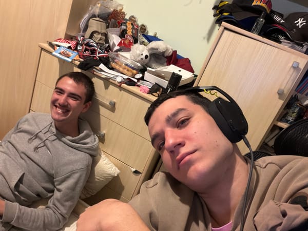 Two young men rest on wooden furniture in Sofia