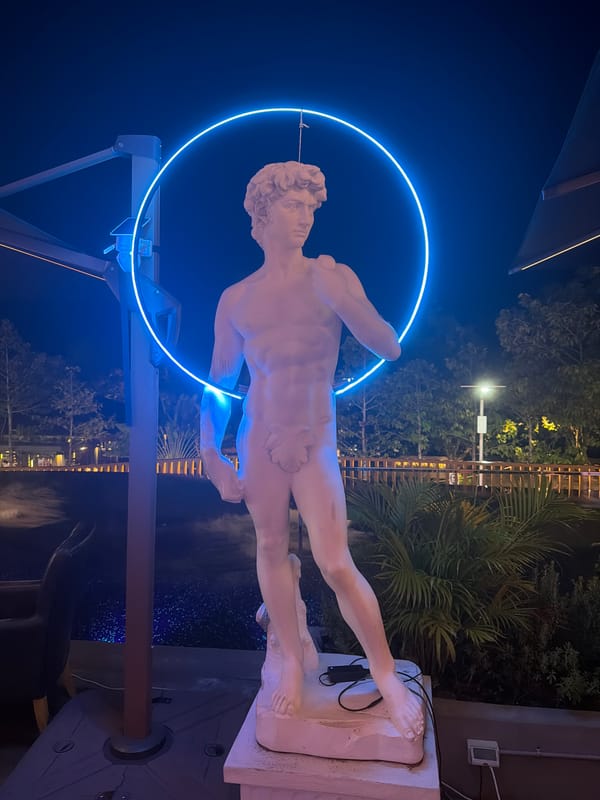 Blue-lit nights in Ko Samui: neon statue and glowing pool