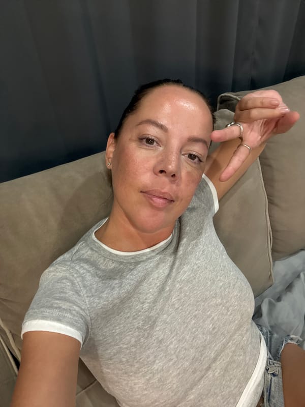Couch hang, peace sign, casual indoor vibe.
