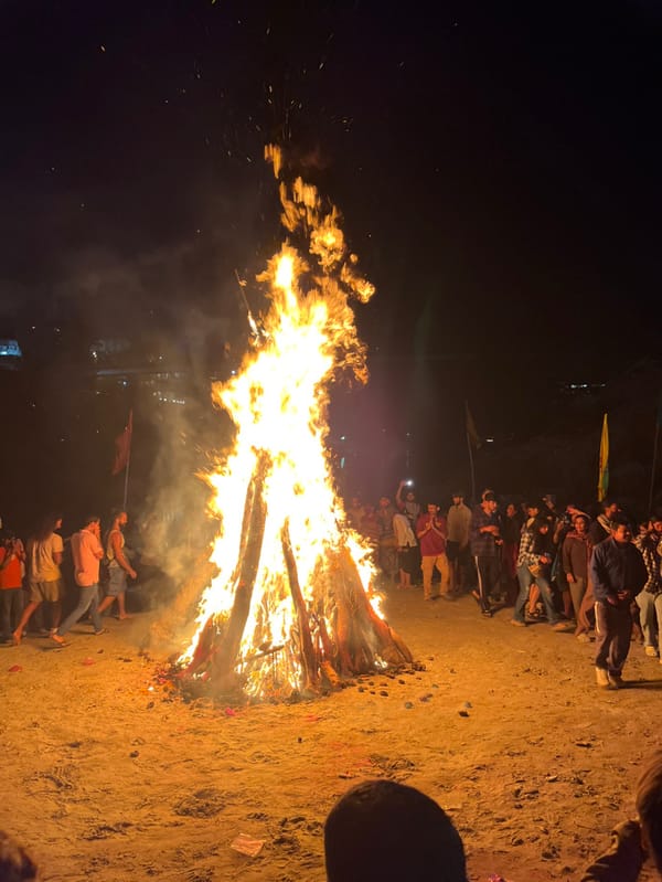 Nighttime bonfire gathering draws crowds along Rishikesh riverbank