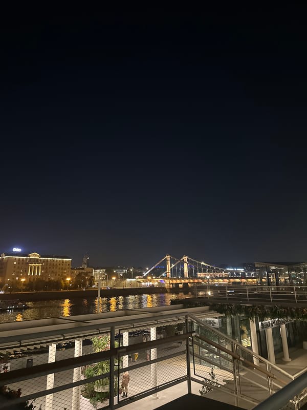 Nighttime city view captured from elevated balcony platform