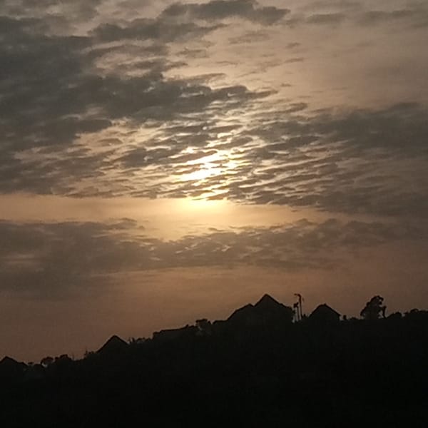 Dawn or dusk captured over silhouetted urban landscape