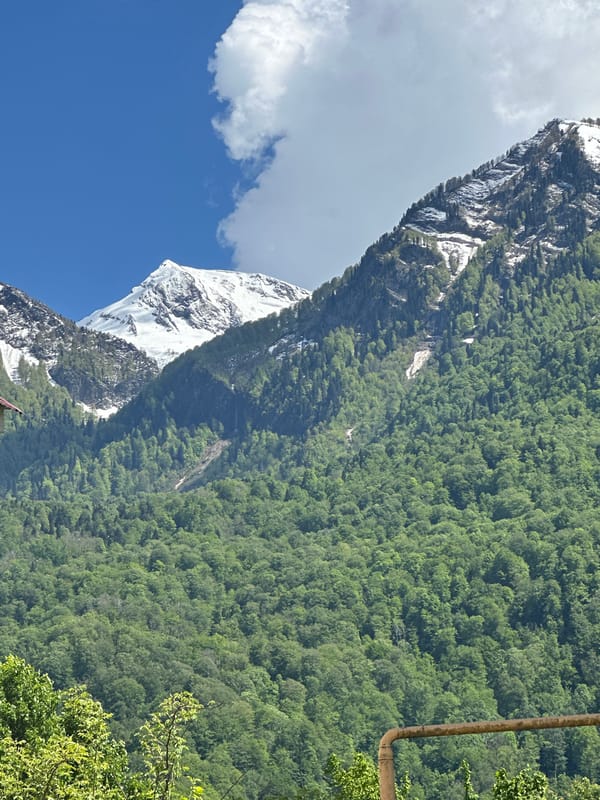 Person walks through scenic Krasnaya Polyana mountain resort