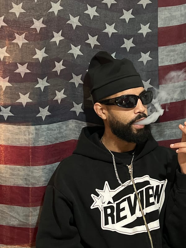 Man photographed smoking and posing with American flag in Tanger