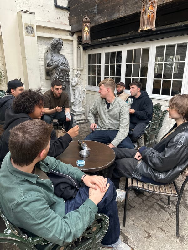 Eight people gather in London outdoor seating area
