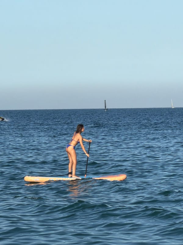 Summer day unfolds at Barcelona's Barceloneta Beach with Elvis performer