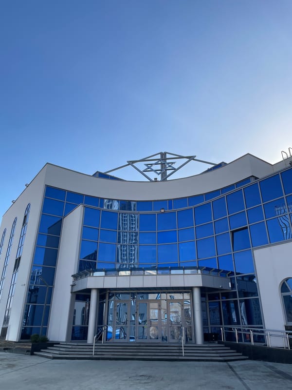 Modern curved glass building exterior photographed in Yekaterinburg