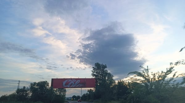 Highway journey documented near Aytos, Bulgaria with billboards, power lines