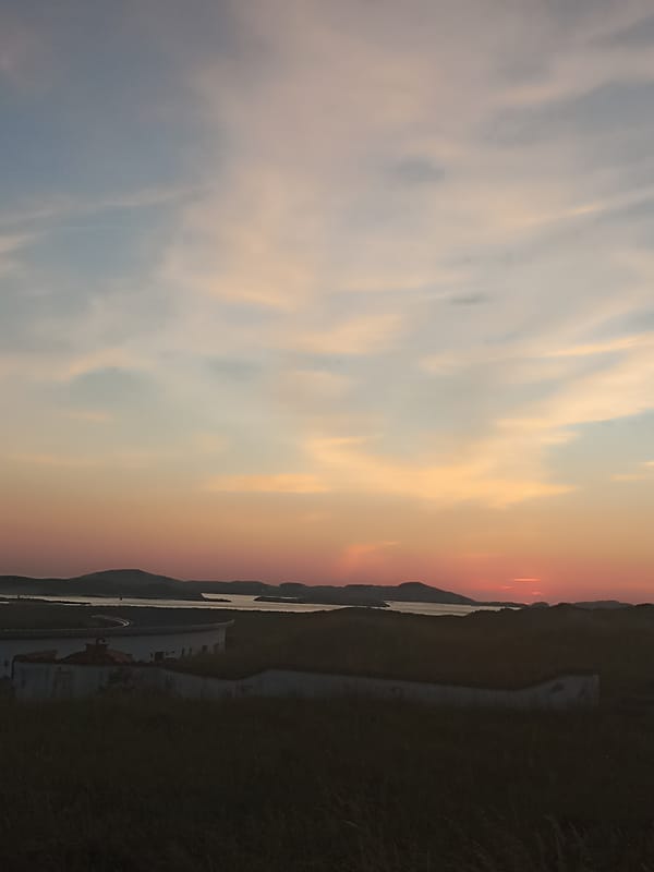 Dusk settles over an Irish coastal village and shoreline