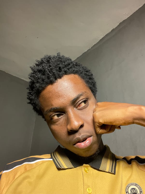 Indoor selfie session in Nkpor, Nigeria, yellow polo and shades
