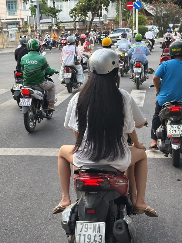 Morning scooter traffic flows through coastal Nha Trang streets