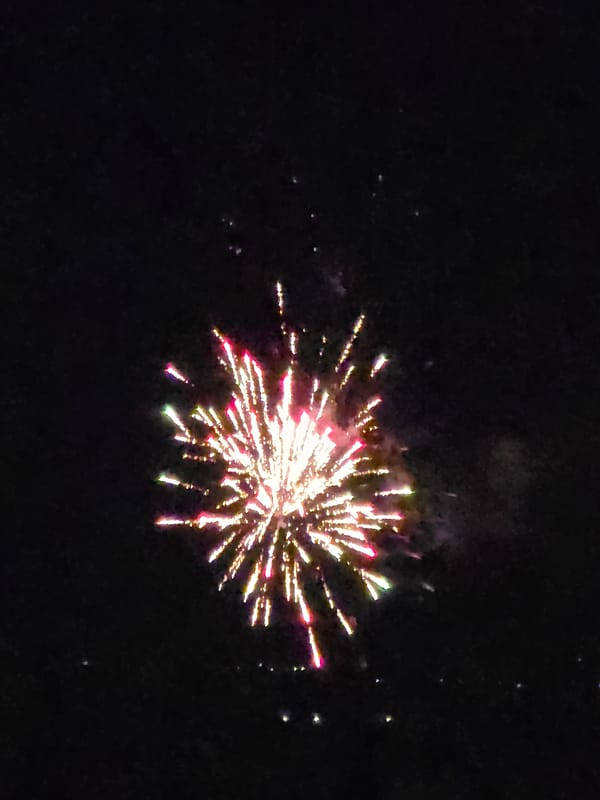Fireworks display lights up night sky over residential area