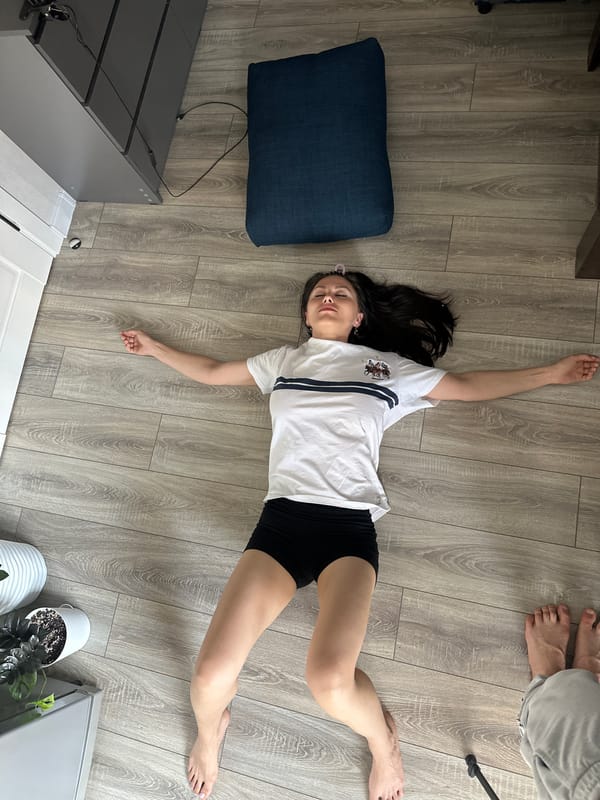 Woman resting on wooden floor in Sinyavino, Russia