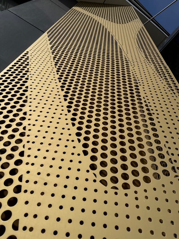 Metal panels with circular cutouts observed on Yekaterinburg building