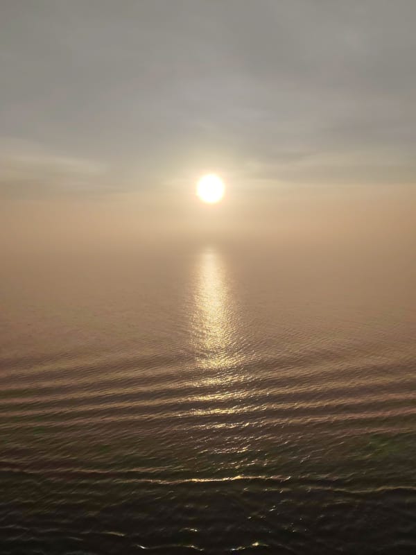 Sunrise observed over Russian waters creates shimmering reflection path
