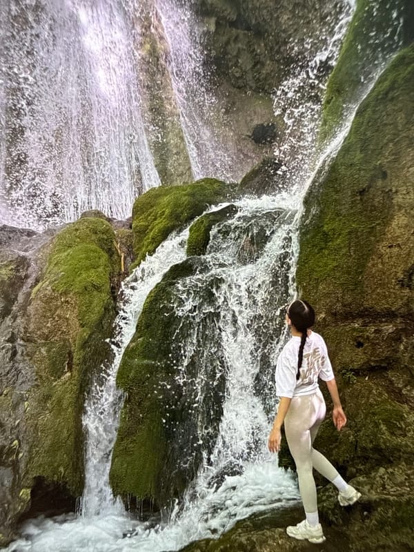 Woman rests beside waterfall in Bulgaria