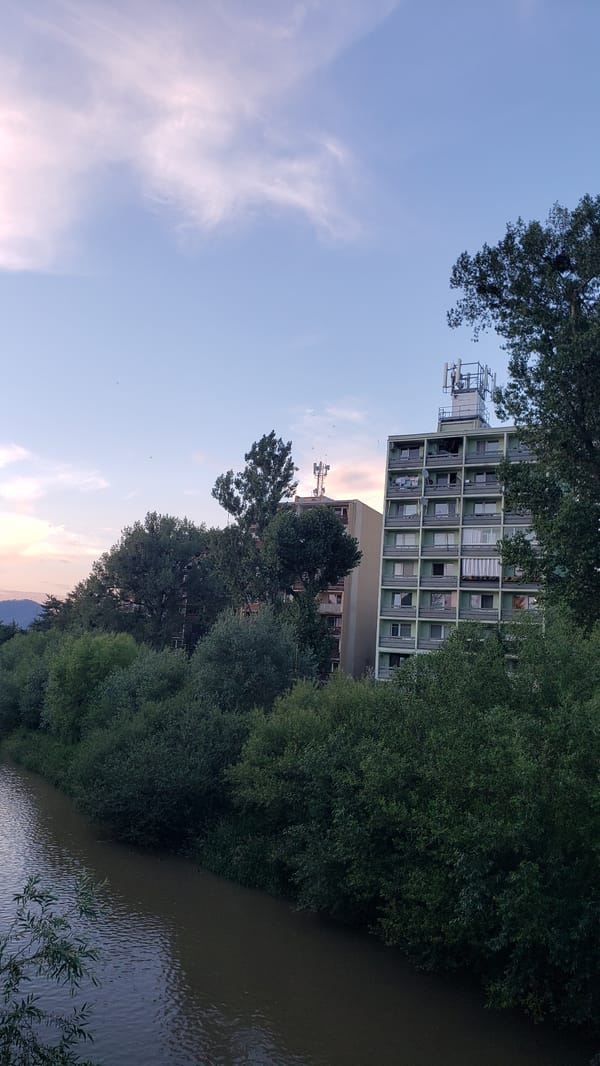 Prešov at golden hour, streets and river under a vivid sunset