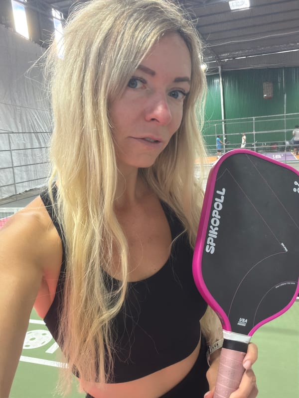 Woman poses with pickleball paddle at Da Lat sports facility