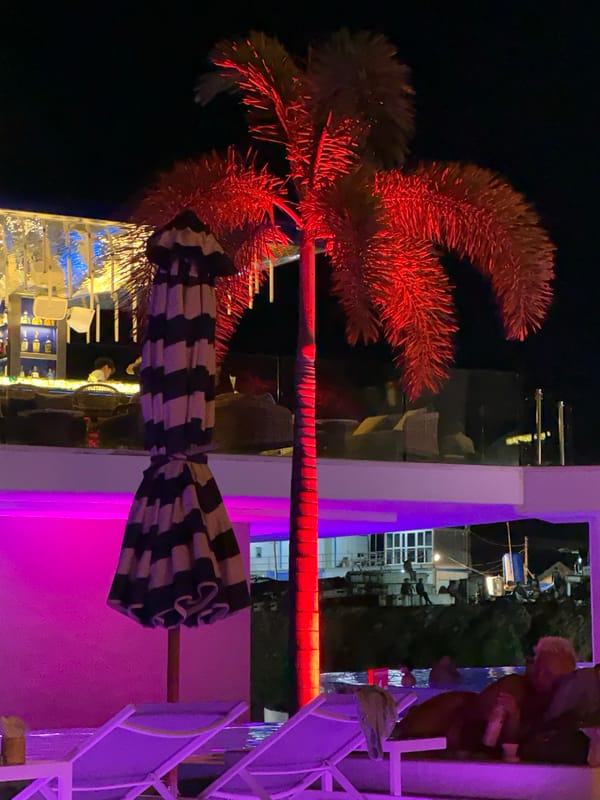 Purple-lit infinity pool and nightlife at a Karon resort