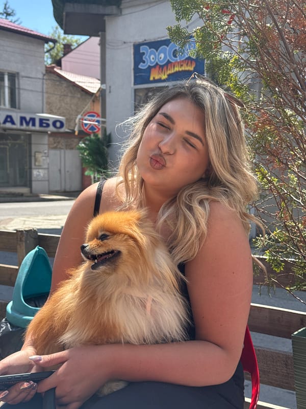 Woman poses with Pomeranian dog in sunny Dupnitsa
