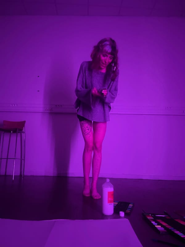 Artist creates colorful artwork in purple-lit Marseille studio