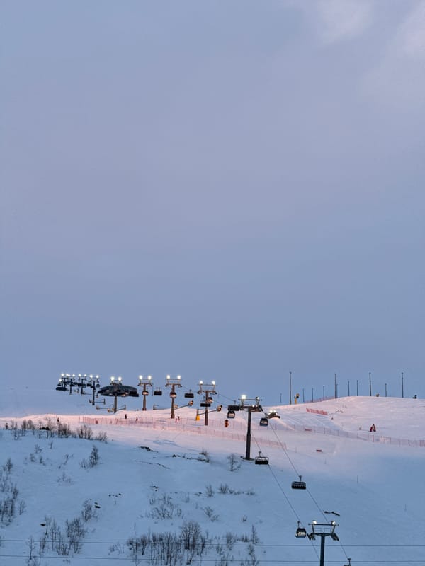 Illuminated ski lift operates at dusk in Kirovsk resort