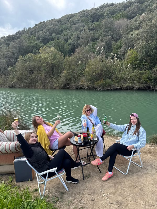 Four women gather by green waters in Prijevor, Montenegro