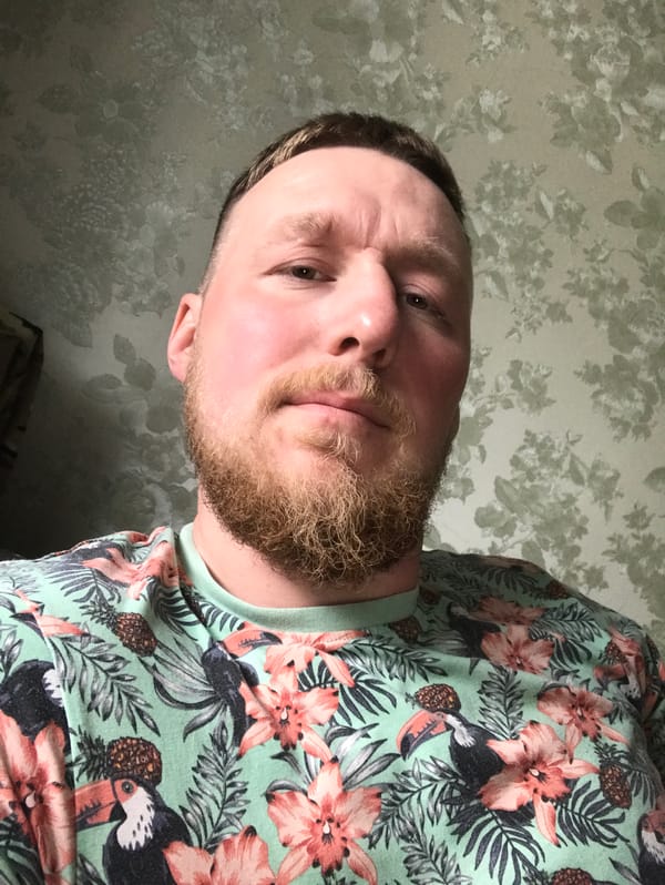 Man in tropical shirt observed resting at location