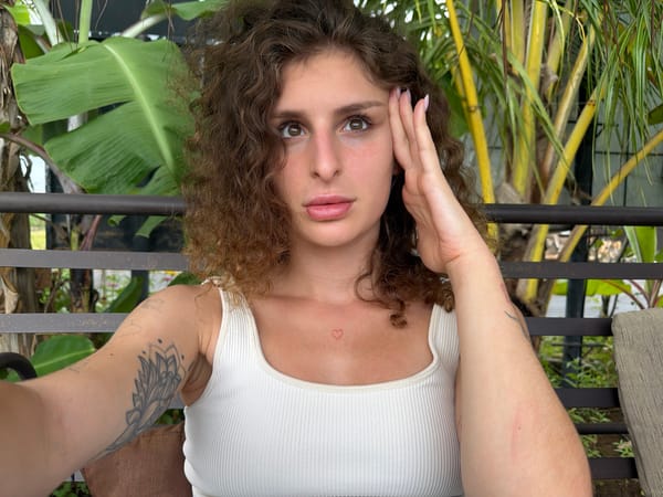 Woman takes selfies at tropical cafe in Mengwi, Indonesia