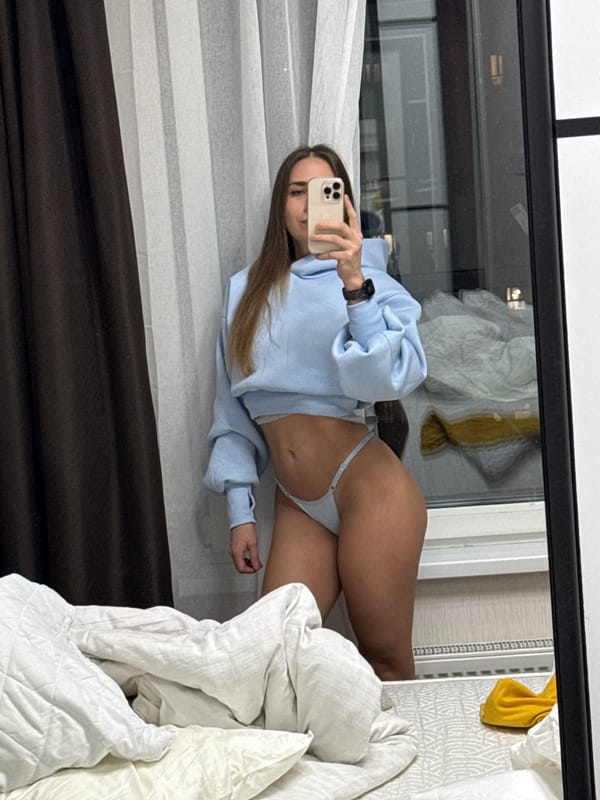 Woman takes mirror selfies in bedroom, Lyubertsy, Russia