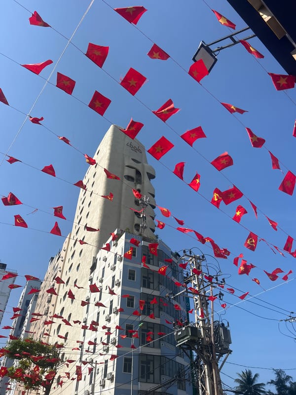 Red flags line street overhead in Bắc Nha Trang