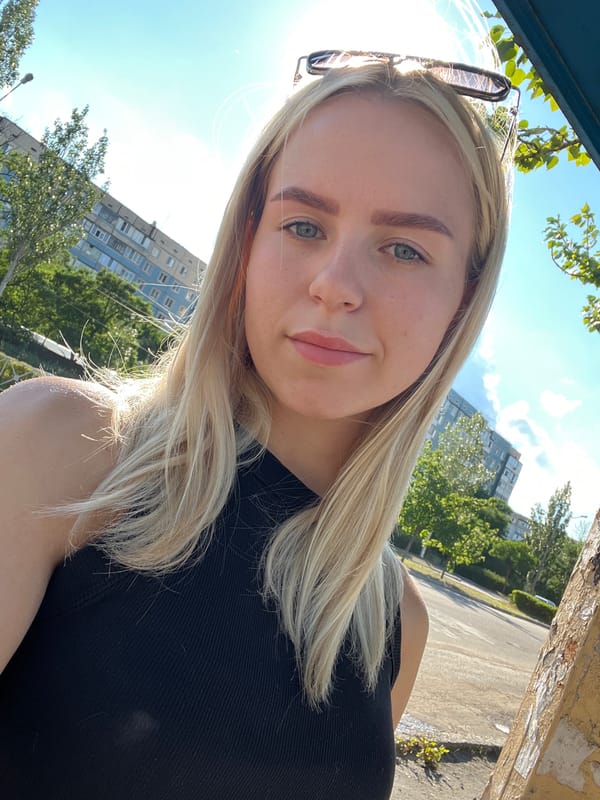 Sunny day selfies on an urban street, peace sign shadow nearby