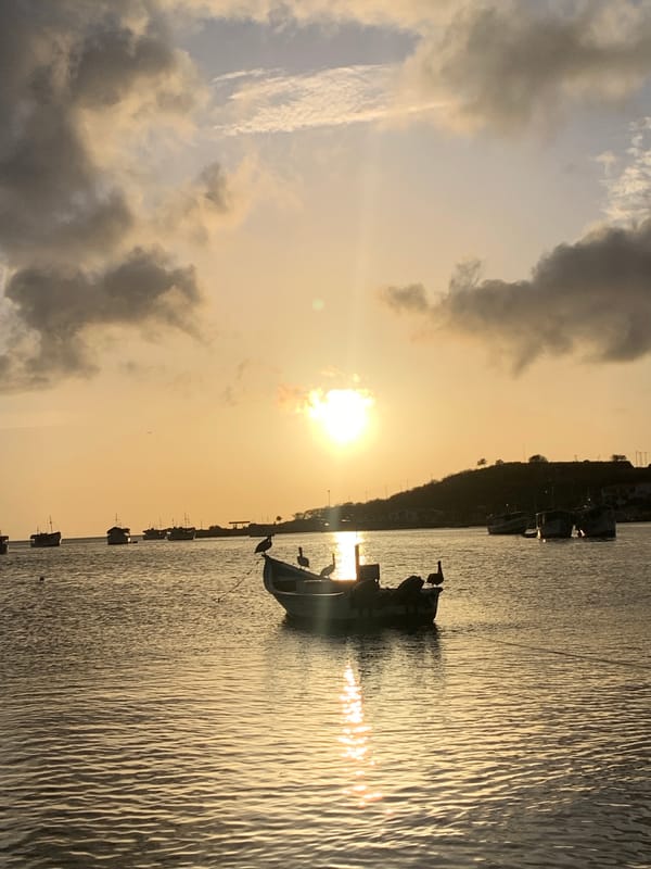 Sunset over Juan Griego's bay, boats and town life