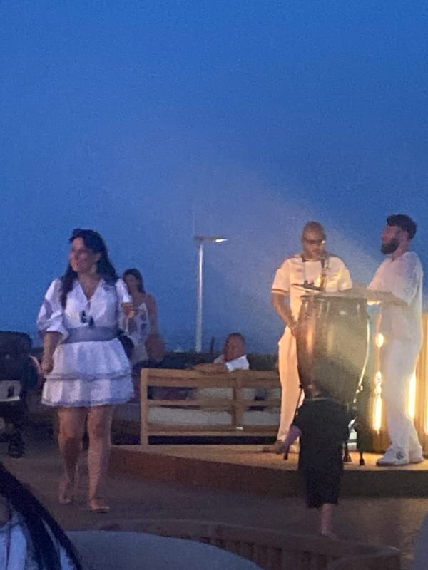 Estepona resort at dusk: coastal paths, live drums, evening crowd