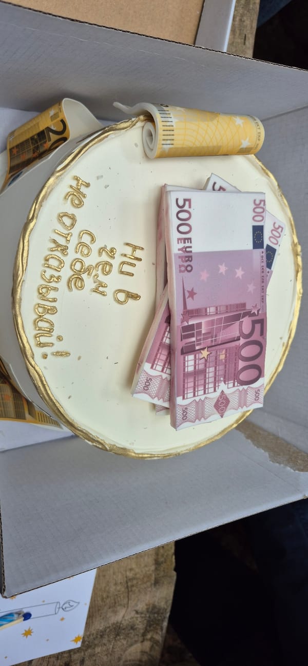 Birthday celebration with Euro-themed cake held outdoors in Montenegro