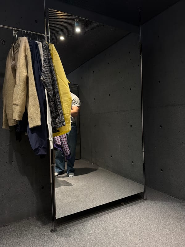 Mirror display with person and clothing rack spotted in Montreal