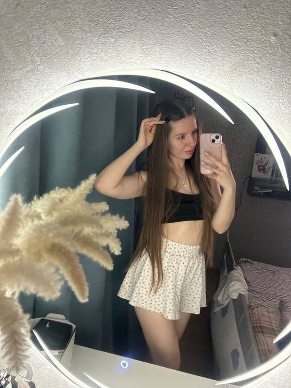 Woman takes mirror selfie in bedroom in Klin, Russia
