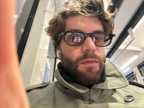 Evening commuter rides Montreal Metro in olive trench coat