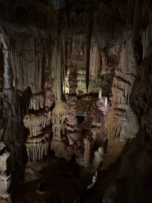 Visitors document limestone formations inside Petralona Cave, Greece