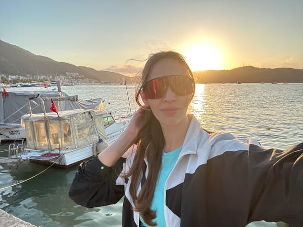 Woman captures sunset selfie at Fethiye harbor, Turkey