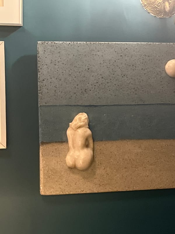 Art collection documented on teal wall in Lisbon