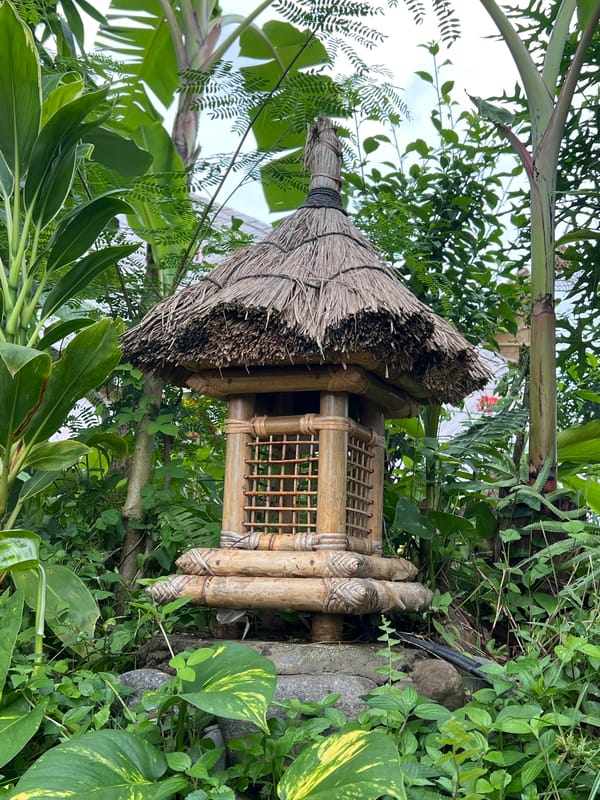 Tourist documents traditional Balinese property features in Ubud