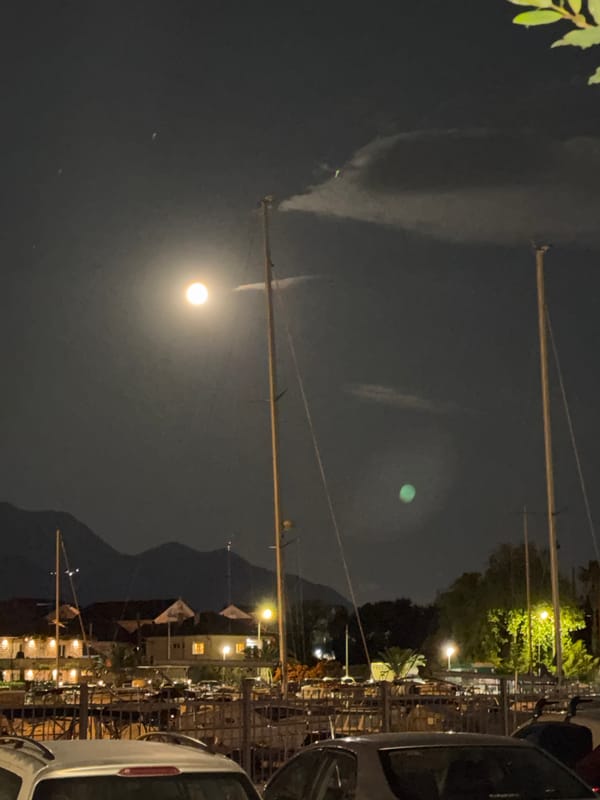 Bright moon illuminates Tivat waterfront on spring evening