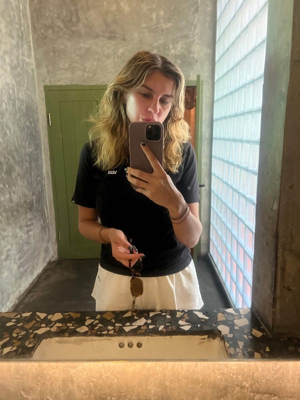 Casual mirror selfie in a concrete bathroom, Kuta Selatan.