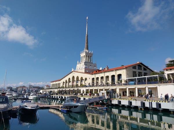 Tourist documents springtime visit to Sochi Seaport with selfies, architecture