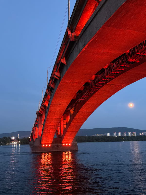 Dusk scenes around a Krasnoyarsk bridge, from deck to river