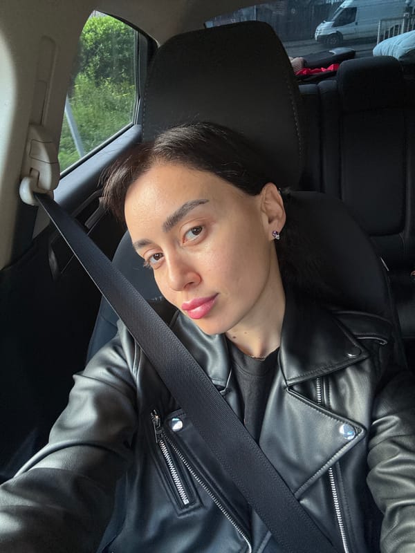 Woman drives through Tbilisi making peace sign gesture