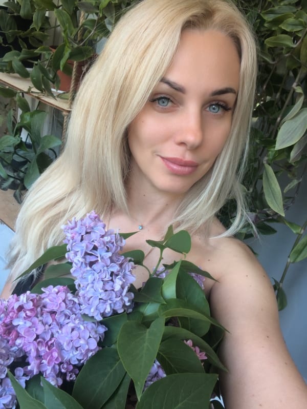 Woman enjoys spring lilacs in Sevastopol